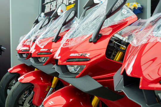 Qingdao,China-May.22.2026:A row of vibrant red ZXMOTO 820RR sportbikes with aerodynamic winglets is lined up inside a dealership showroom.