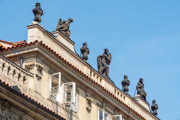 Rooftop statues on historic european building under blue sky © Mirko