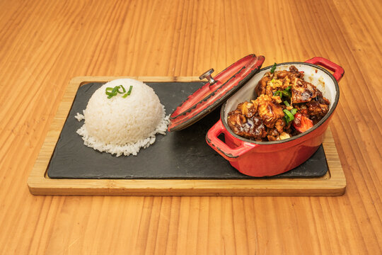 A ladleful of a delicious Filipino recipe for stewed pork and a ladleful of white rice