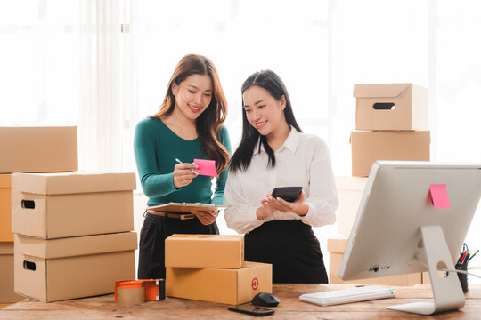 Online Business Collaboration: Two female entrepreneurs enthusiastically plan their next move for their burgeoning e-commerce venture.