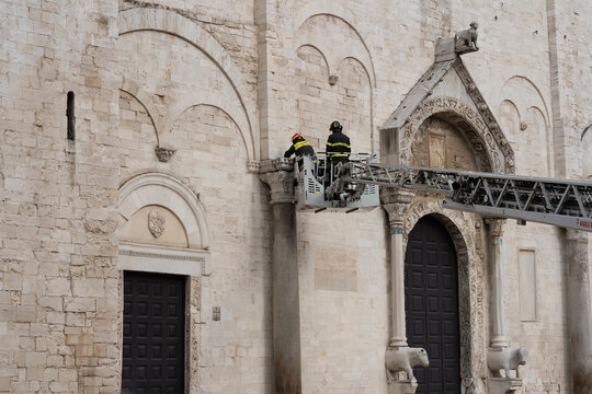 A fire crew removes dirt from the Church of Saint Nicholas in Bari.