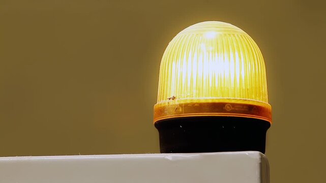 Close Up of Amber Industrial Warning Beacon Flashing as Safety Signal Light - 4K