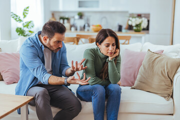 Obraz premium Couple Having Serious Argument on Sofa in Living Room During Relationship Dispute