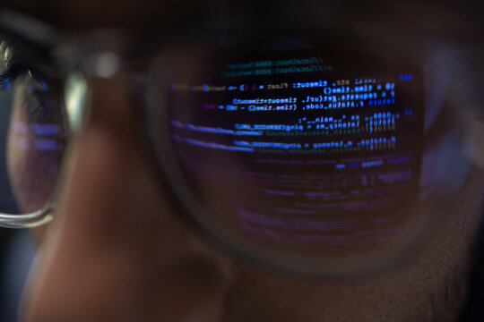 Close Up Of Programmer Glasses With Code Reflection On Lens