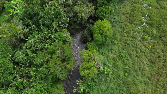 Drone flight across green mountain and river valleys  in Boyac&aacute;