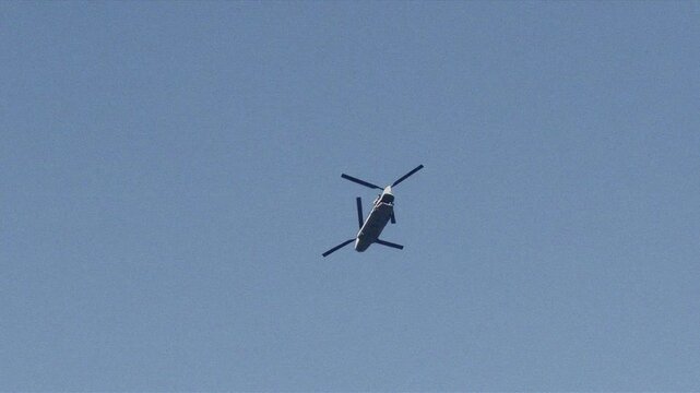 Recon helicopter scouting the blue skies for film footage or military surveillance. Boeing CH-47