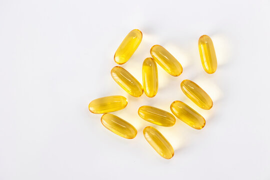 Yellow omega 3 fish oil capsules isolated on white background with copy space. Dietary supplement and healthy lifestyle concept.