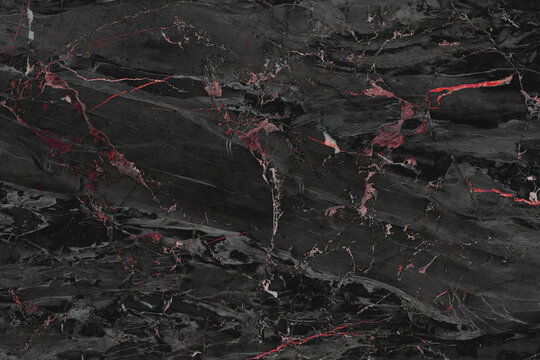 A close-up, textured shot of black marble with striking red veins running through it, creating a dramatic and luxurious pattern. The interplay of dark and vivid colors suggests depth and elegance.