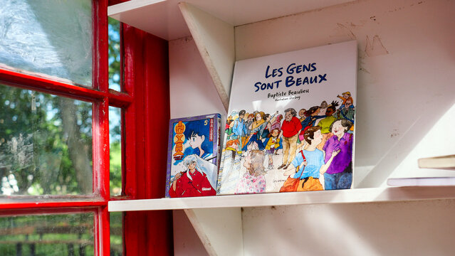 PERPIGNAN, FRANCE - MAY 19, 2026: A public book-sharing cabinet (street library) installed in a city center park. Free books box for citizens, urban lifestyle and community sharing.