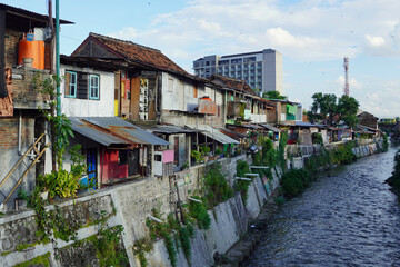 Fototapeta premium Urban canal flowing through a residential neighborhood