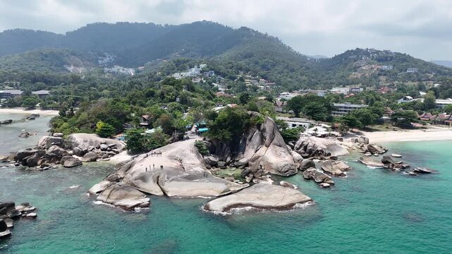 Aerial Pull Back and Rise from Hin Ta Hin Yai Rocks Revealing Lamai Coastline Koh Samui Thailand