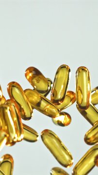 Softgel vitamins drifting across pale studio, production line quality Filmed on a high-speed camera at 1000 fps.