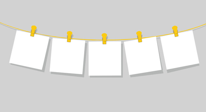 Five blank square photo frames hanging on a yellow clothesline with pins against a neutral gray background for copy space.