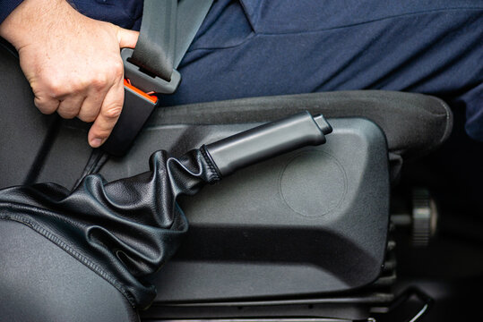 Driver pulling handbrake in car interior photo