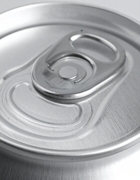 Close-up macro shot of the silver pull-tab and textured top of a beverage can