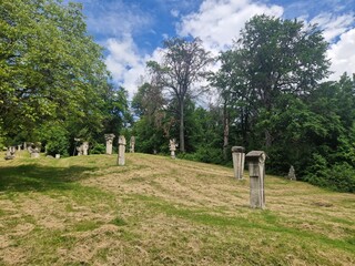 Open-air museum stones in various shapes carved over time exhibited in the middle of nature in a forested mountain glade © Langa