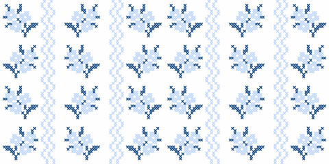 Blue cross stitch floral seamless pattern with traditional embroidery folk art motifs. © oxygen_8