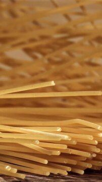 Spaghetti falling on a wooden table. Filmed on a high-speed camera at 1000 fps. High quality FullHD footage