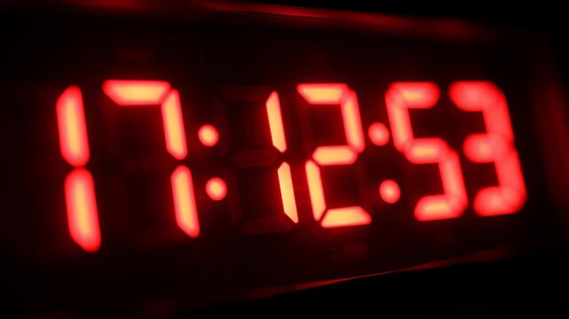 Digital Clock Displaying Time in Red LED Digits Close Up.