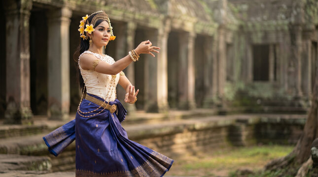Cambodian woman performing traditional Apsara dance in ancient temple  