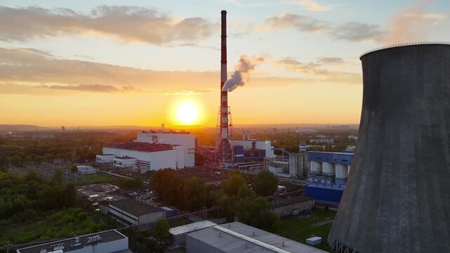 Industrial power plant with smokestack emits steam against sunset backdrop, showcasing gradual light change and landscape details in the foreground and background across three frames