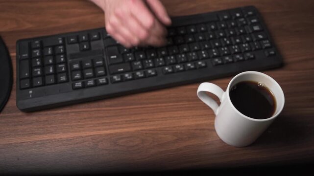 Placing coffee cup on table and starting work in office