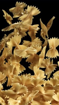 Farfale pasta flies in and falls. Filmed on a high-speed camera at 1000 fps. High quality FullHD footage