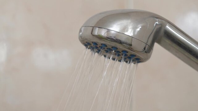 Water flows out of shower head with sound. Shower head in bathroom, close-up shot video with sound
