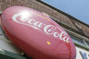 Fototapeta premium vintage round Drink Coca-Cola button sign outside Kingston Road Flower Market, 966 Kingston Rd, Toronto