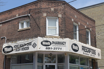 Fototapeta premium exterior building facade and sign of Woods Pharmacy located at 130 Kingston Rd, Toronto