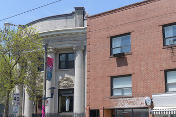 Fototapeta premium historic Canadian Bank of Commerce building (now location of Stephan Caras Design Inc) and recent commercial block at 744 and 750 Queen St E, Toronto