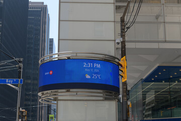 Fototapeta premium date, time, and weather electronic sign outside BMO, Bank of Montreal Financial Group headquarters at First Canadian Place, King and Bay, Toronto