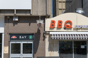 Fototapeta premium secondary Line 2, Bay station entrance and BBQ Express signage at 18 Bellair St #12, near Cumberland St, Yorkville, Toronto