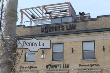 Naklejka premium ghost signs outside Murphy's Law Pub and Kitchen at 1702 Queen St E and Penny Ln, Toronto