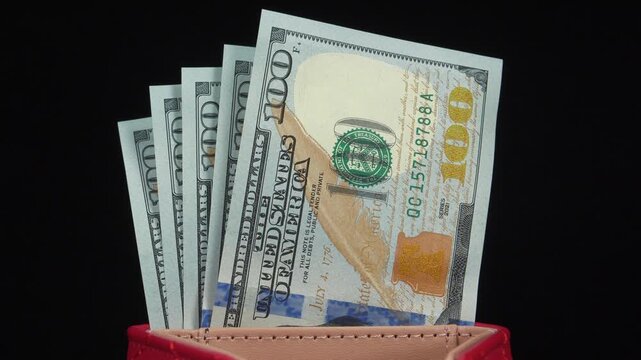 American dollars in wallet. Five new blue 100 dollar bills. 500 dollars banknotes in wallet. Cash, finance, savings, wealth. New hundred dollar bills in red leather wallet