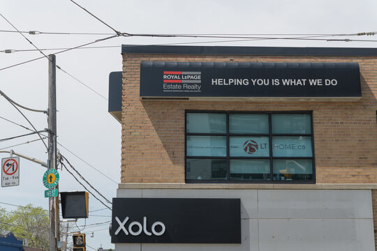 exterior building with sign of Xolo, a day spa, and Royal LePage, a real estate agency, located at 1052 Kingston Rd (corner of Victoria Park Av), Toronto