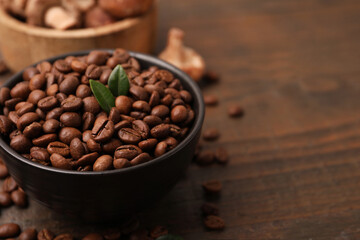Fototapeta premium Coffee beans and mushrooms on wooden table, closeup. Space for text
