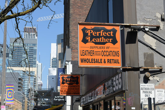 vintage projecting signs outside Perfect Leather Goods Ltd located at 555 King St W, Toronto