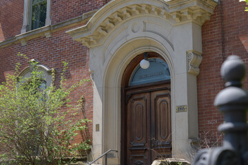 Naklejka premium entrance portal with stone frame and sign at George Brown House located at 186 Beverley St, Toronto