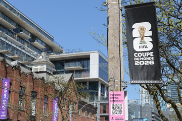 Naklejka premium pole-mounted banner for FIFA World Cup tournament (with text in French) on King St W (defocused view of Fashion House condo), Toronto