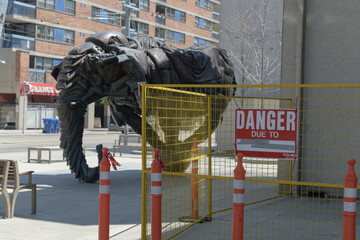 Naklejka premium construction fence and Danger sign near Couch Monster: Sadzěʔ yaaghęhch'ill by Brian Jungen outside Art Gallery of Ontario, corner of McCaul St, Toronto