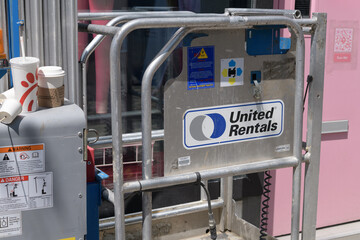 Naklejka premium aerial work platform (also called lift platforms or mobile elevated work platforms/MEWPs) with United Rentals sticker and other objects on Queen St W, Toronto