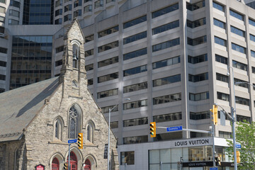 Naklejka premium wide view of northeast corner of Avenue Rd and Bloor St W, incl Louis Vuitton, a leather goods store, located at 150 Bloor St W, Toronto
