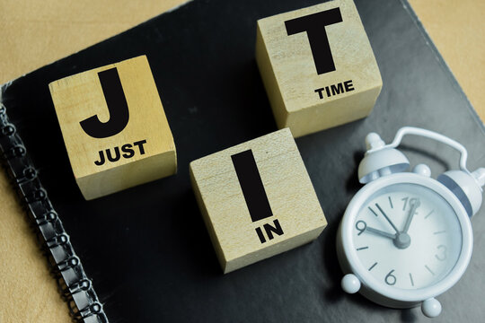 Concept of text JIT - Just In Time on wooden blocks.