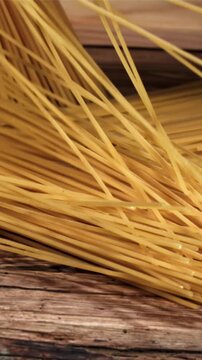 Spaghetti falling on a wooden table. Filmed on a high-speed camera at 1000 fps. High quality FullHD footage