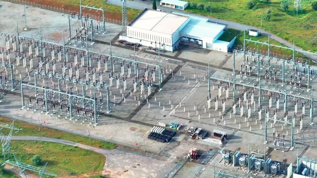 High voltage power substation with complex electrical grid and extensive transmission lines observed from an aerial perspective