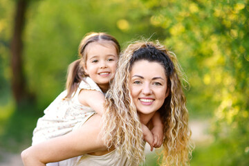 Naklejka premium Mother with her cute little daughter in nature