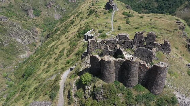 Aerial view of the historic medieval Amberd Fortress in Armenia on a sunny summer day under a blue sky. Spring scene, shot with a drone