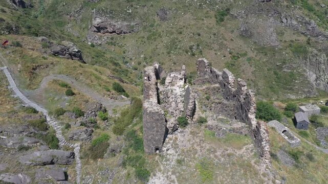 Aerial view of the historic medieval Amberd Fortress in Armenia on a sunny summer day under a blue sky. Spring scene, shot with a drone