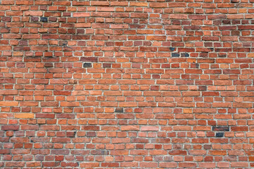 Fototapeta premium Old red brick wall texture background with weathered masonry pattern and rustic architectural surface